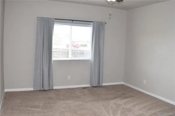 a spacious bathroom with a granite countertop sink toilet and shower