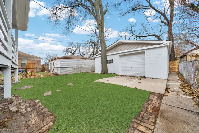a view of a backyard with a large tree