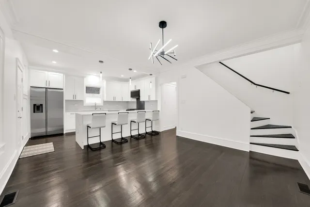 a view of kitchen with cabinets and wooden floor