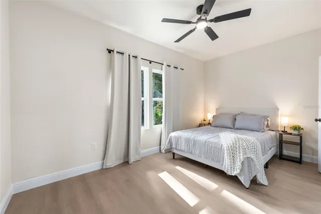 a bedroom with a bed and a chandelier