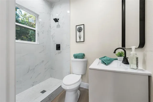 a bathroom with a sink toilet and shower