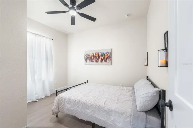 a bedroom with a bed and a chandelier