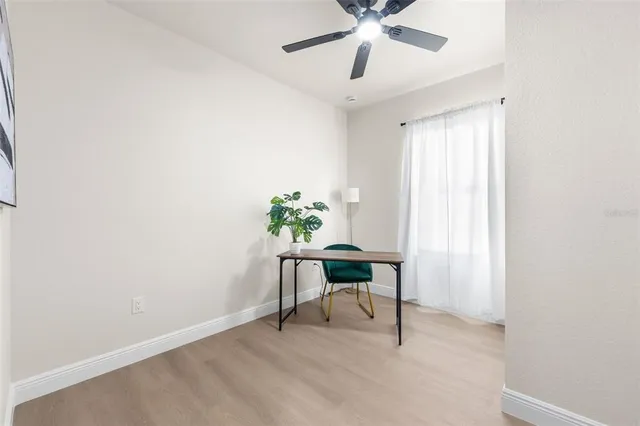 a view of a workspace with furniture and a window