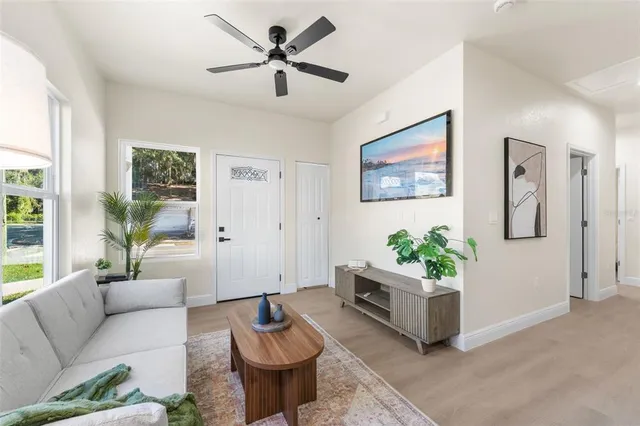 a living room with furniture and a potted plant