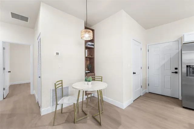 a view of a room with furniture and wooden floor