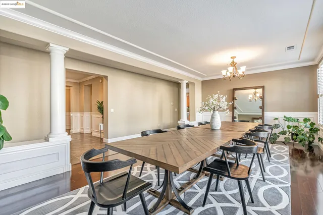 a view of a dining room with furniture and chandelier