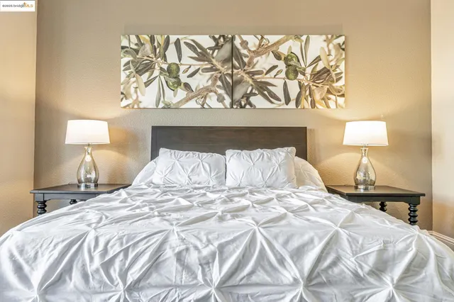 a bedroom with a bed window and a flat screen tv