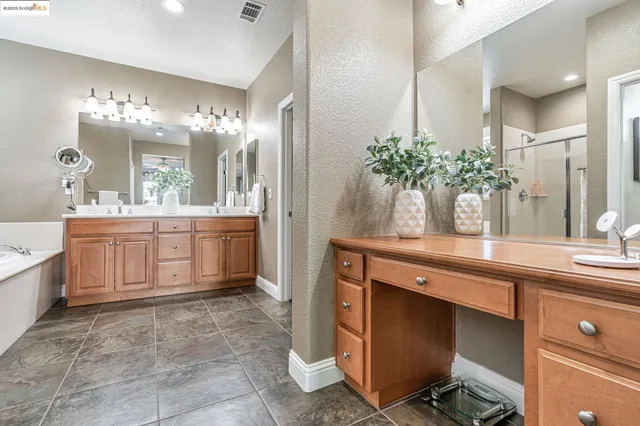 a bathroom with a tub shower and sink