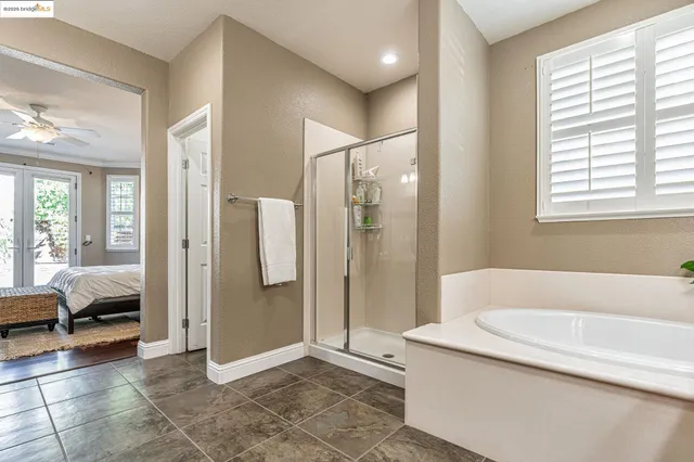 a living room with a large window and furniture