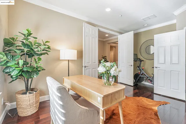 a bedroom with a bed and a potted plant