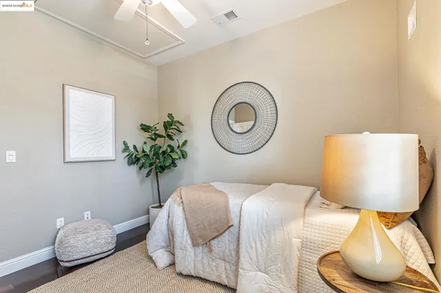 a bed room with a bed and a potted plant