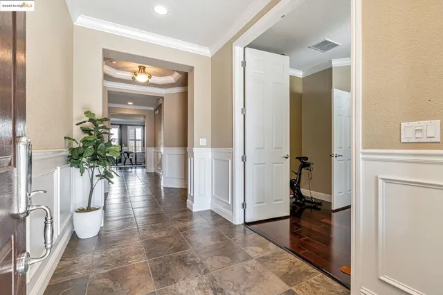 a living room with furniture a flat screen tv and a large window