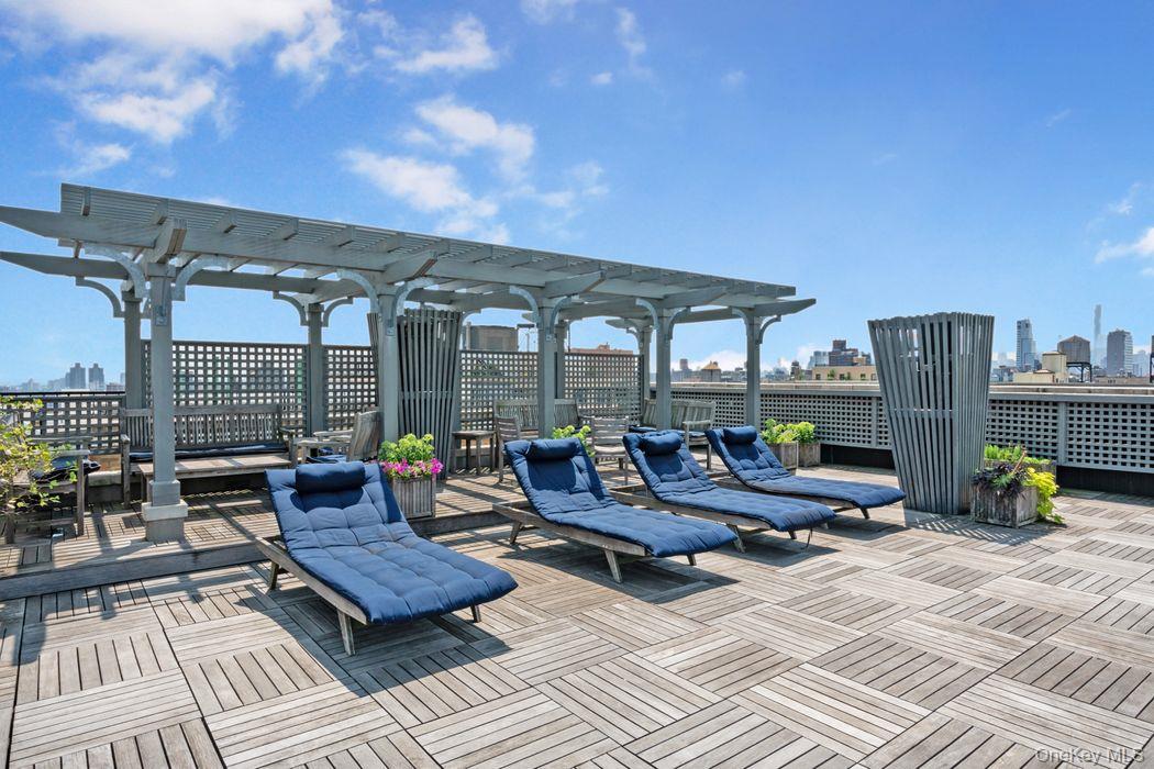 390 Riverside Drive, Unit 12AC Manhattan, NY 10025 - Photo 18 of 29 Wooden terrace featuring a pergola and a skyline view