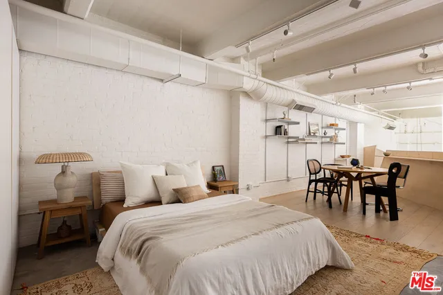 a bedroom with a bed and chair