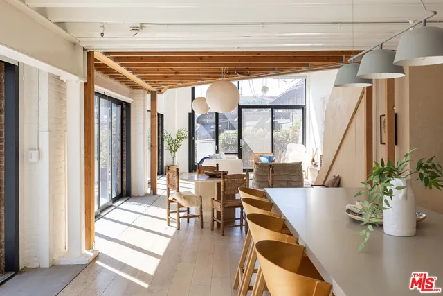 a dining room with wooden floor and furniture