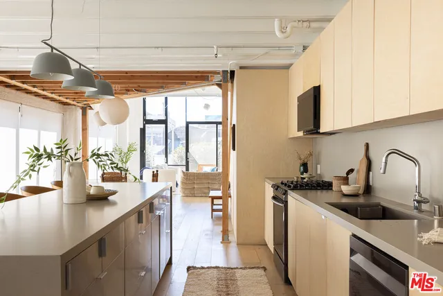 a kitchen with sink a window and cabinets
