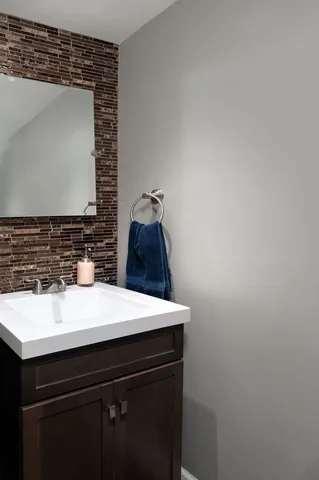 a bathroom with a sink a vanity and a mirror
