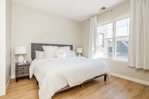 a bedroom with a bed and a window