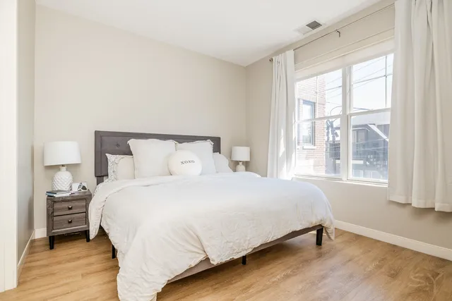 a bedroom with a bed and a window