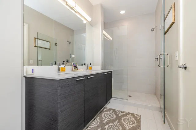 a bathroom with a bathtub sink vanity and mirror