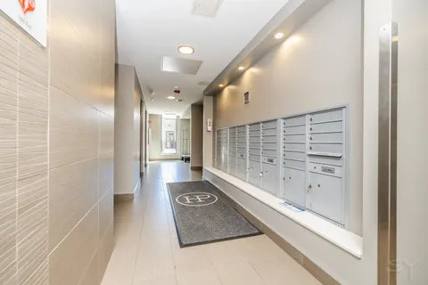 a bathroom with a granite countertop sink a toilet and shower