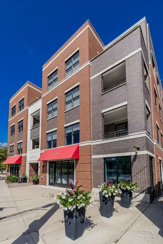 a front view of building with small garden