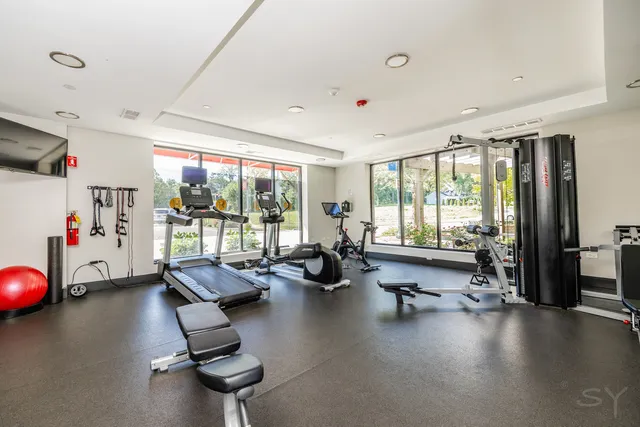 a room with gym equipment and a large window