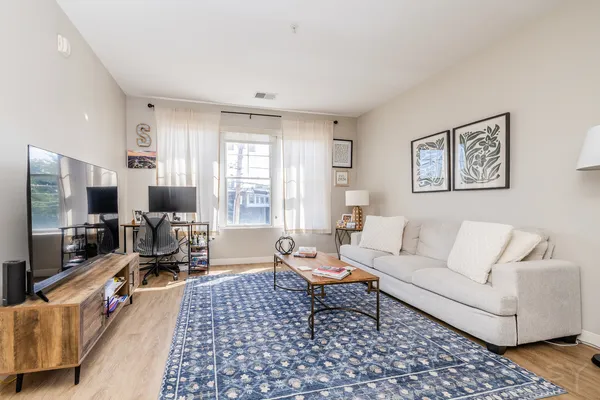 a living room with furniture and a flat screen tv