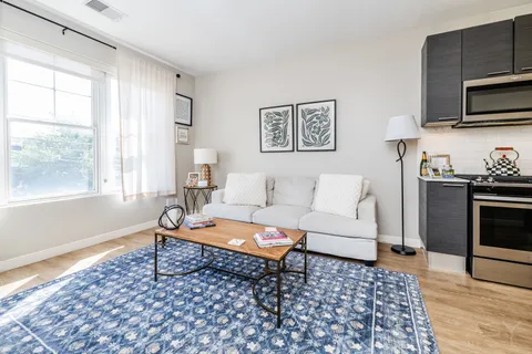 a living room with furniture and wooden floor