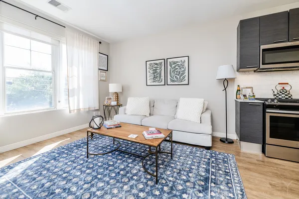 a living room with furniture and wooden floor