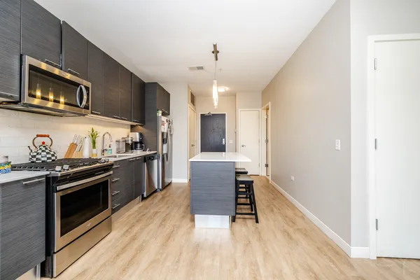 a kitchen with stainless steel appliances granite countertop a stove and a refrigerator
