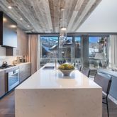 a kitchen with a sink a counter top space and stainless steel appliances