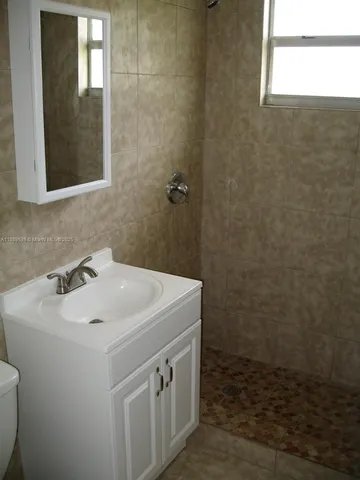 a bathroom with a sink a toilet and mirror