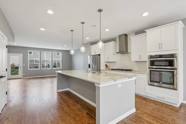a kitchen with stainless steel appliances kitchen island a large island in the center
