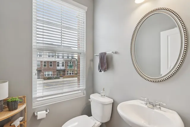 a bathroom with a toilet a sink and a mirror