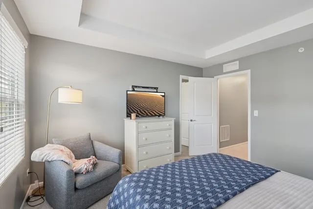 a bedroom with a bed and a couch