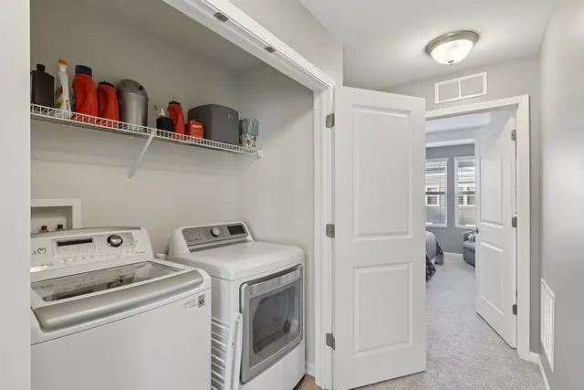a view of storage and utility room with washer and dryer