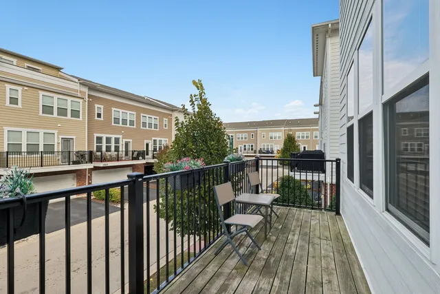 a view of a balcony with wooden floor and fence