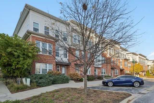 a front view of a building with trees