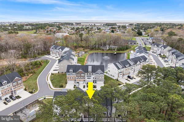an aerial view of a house with outdoor space swimming pool and ocean view