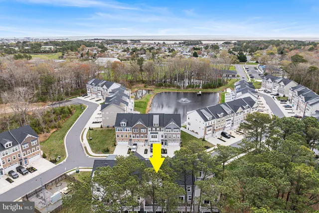 an aerial view of a house with outdoor space swimming pool and ocean view