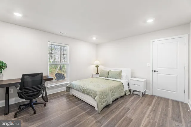 a bathroom with a granite countertop sink a toilet and a mirror