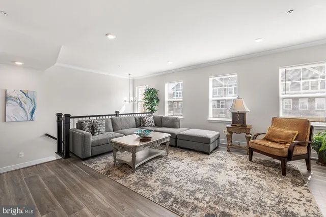 a living room with furniture and kitchen view