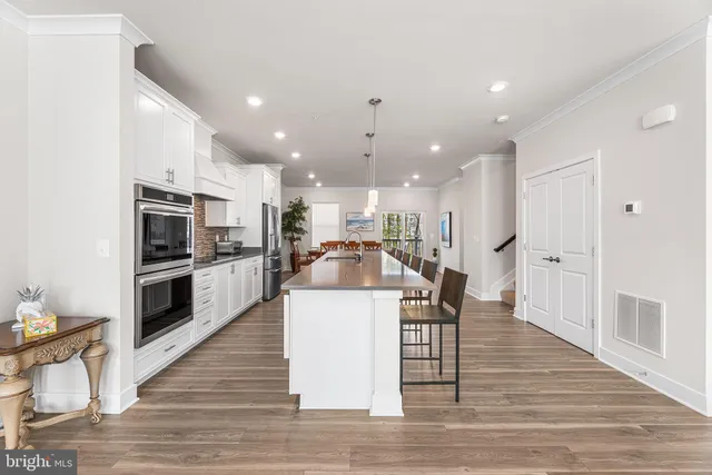 a dining room with furniture a window and wooden floor