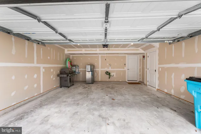 a spacious bedroom with a bed and a dresser