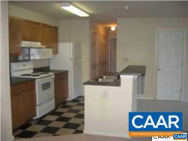 a kitchen with a stove and a refrigerator