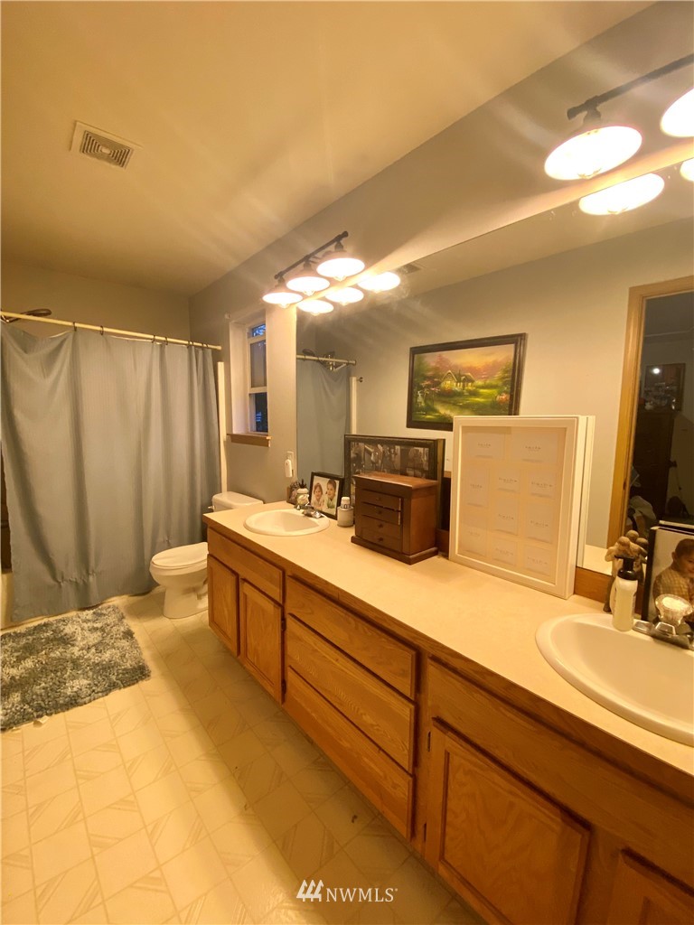 8016 188th Avenue Southwest Rochester, WA 98579 - Photo 11 of 16 a spacious bathroom with a double vanity sink and a mirror