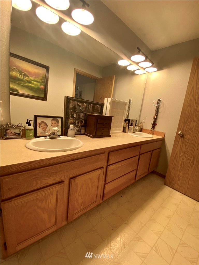 8016 188th Avenue Southwest Rochester, WA 98579 - Photo 12 of 16 a bathroom with a sink double vanity and a mirror