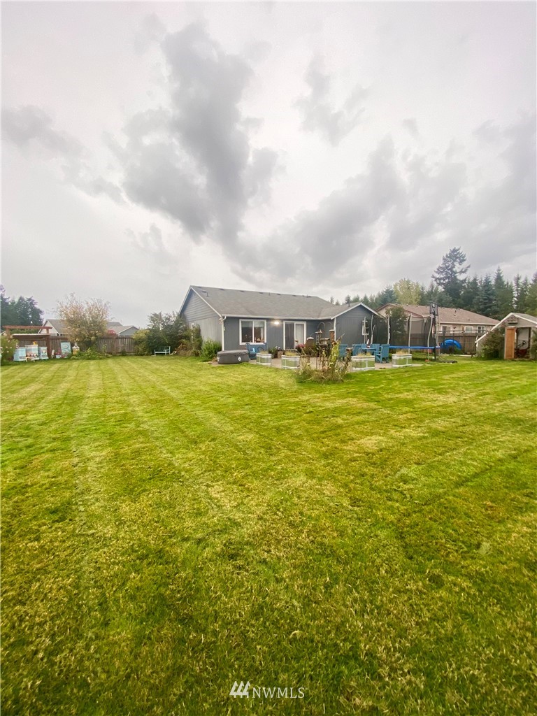 8016 188th Avenue Southwest Rochester, WA 98579 - Photo 13 of 16 a view of a large pool with lawn chairs and large trees