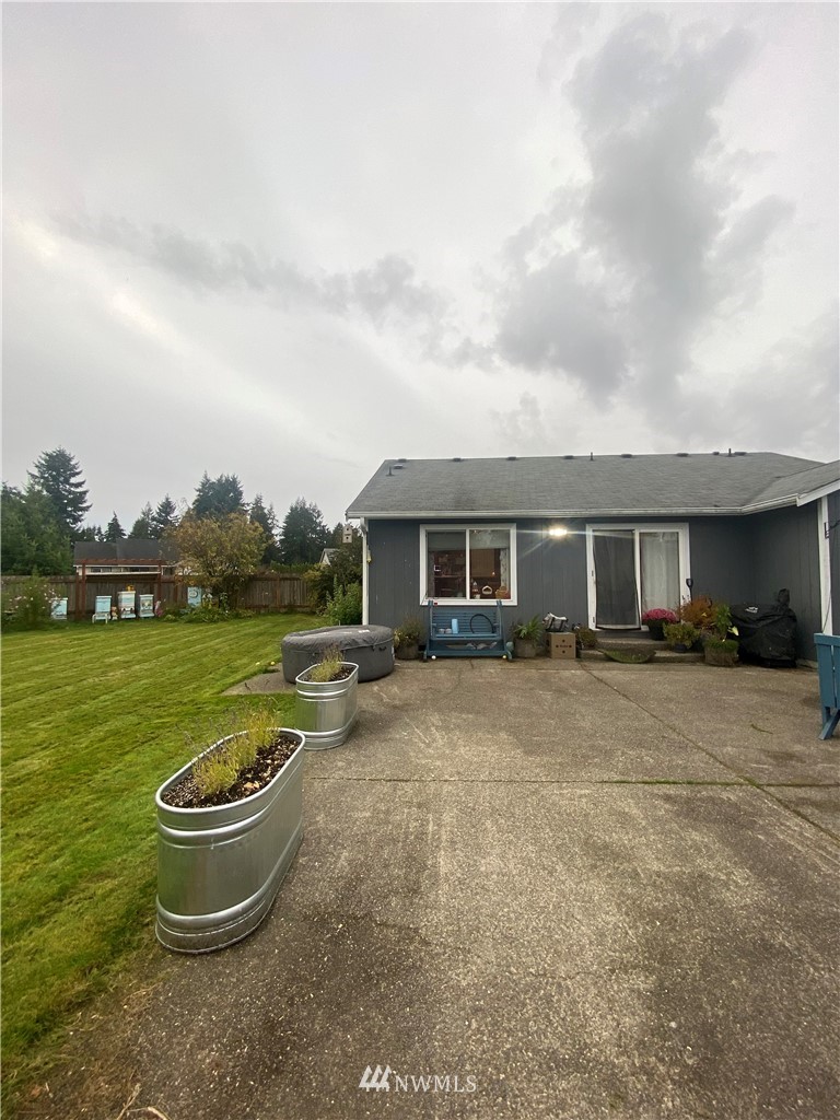 8016 188th Avenue Southwest Rochester, WA 98579 - Photo 14 of 16 a front view of a house with a yard and many windows